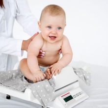 Measuring the baby's weight on a baby scale