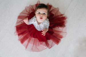 A baby girl dressed in a pink tutu, radiating joy and elegance