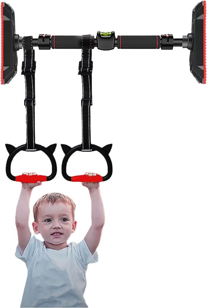Baby playing on doorway-mounted pull-up bars